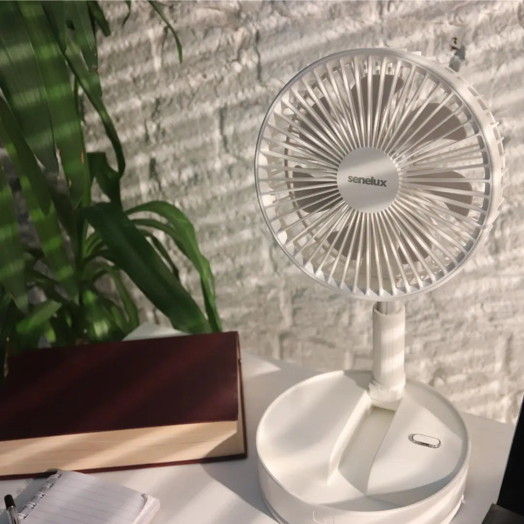 A photo of the Senelux 6" clip on fan, firmly clipped onto the side of a clean white desk.