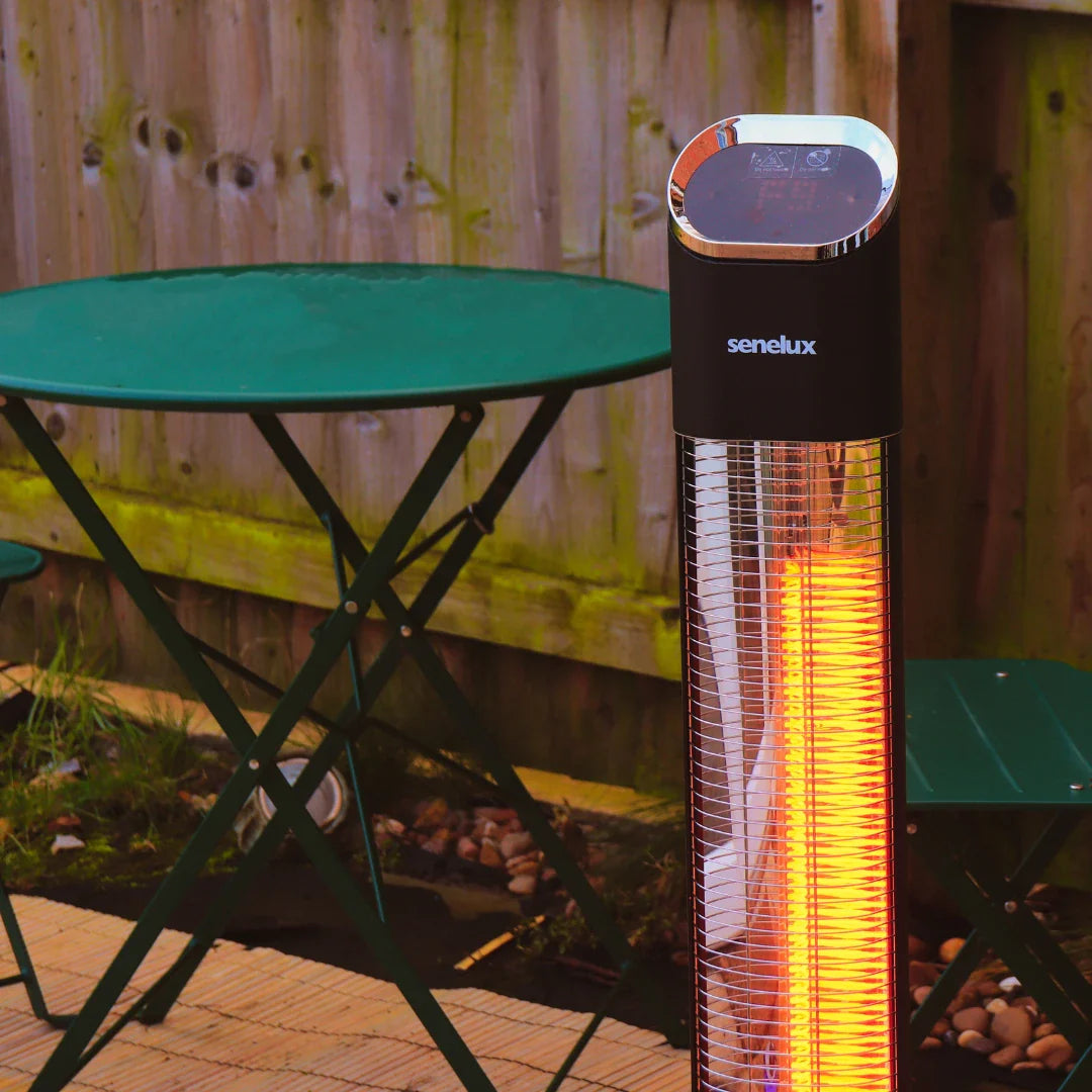 An image of the Senelux Desktop Space Heater on a desk warming up someone's hands as they try to write.